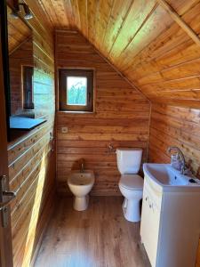 a wooden bathroom with a toilet and a sink at Kopalino 7th Heaven in Kopalino +13 photos