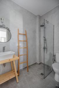 a bathroom with a sink and a shower and a toilet at Sea Houses SERIFOS in Rámos +53 photos
