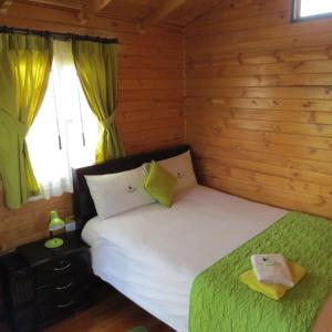 Postel nebo postele na pokoji v ubytování Hosteria Airport Garden