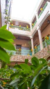 a building with stairs and plants in front of it at Hotel imouzzer in Marrakech