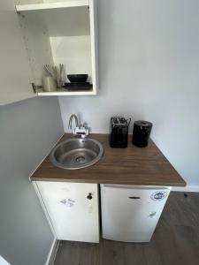 a kitchen with a sink and a counter top at Letzi Private En-Suite Near Wembley in London