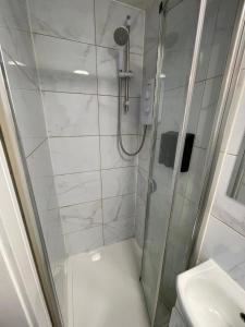 a bathroom with a shower and a sink at Letzi Private En-Suite Near Wembley in London