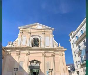 a tall building with a clock tower on top of it at Rosina Apartament il corso in Torre del Greco
