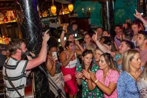 a crowd of people are standing in a bar at Skeffington Arms Hotel in Galway