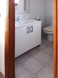 a bathroom with a white sink and a toilet at Spacious apartment in Playa Flamenca with shared pool in Playa Flamenca