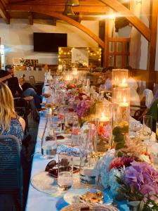 a long table with plates of food and flowers on it at Rákóczi Center in Odorheiu Secuiesc