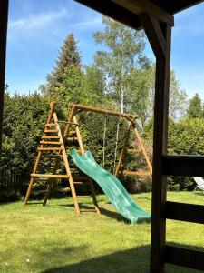a playground with a slide and a ladder at Kopalino 7th Heaven in Kopalino