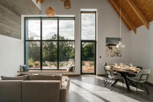 a living room with a table and a large window at Apartamenty Na Potokach in Żegocina