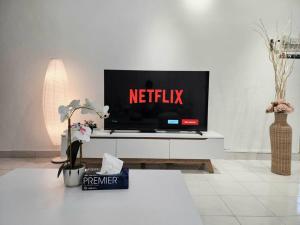a living room with a tv with a netflix sign on it at Petaling Jaya SS14 Bungalow for 20Pax, Plaza33 , 3 2 Square, Jaya One , SS2 in Petaling Jaya