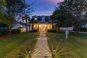 a house with a pathway in front of a yard at A World Away by Newman-Dailey in Destin