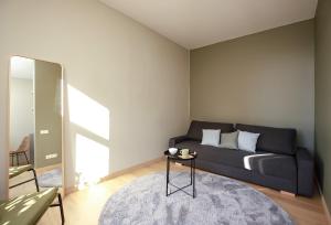 a living room with a couch and a table at Design apartments between National Art Museum and Arena Riga in Rīga