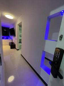 a room with a room with blue lights on the wall at Laureles best location with Jacuzzi and AC in Medellín