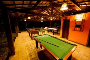 a pool table in the middle of a room at Pousada Bichelenga in Imbassai