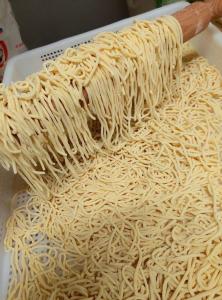 a pile of noodles on a table with a knife at Cuccaro Club - Val di Vara e Cinque Terre in Rocchetta di Vara