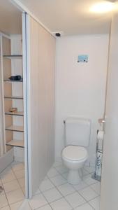 a bathroom with a white toilet in a room at Appartement d'une chambre avec vue sur la mer et wifi a Granville in Granville
