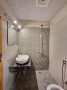 a bathroom with a sink and a shower at The Life Style Lodges opp Centaurus Mall in Islamabad
