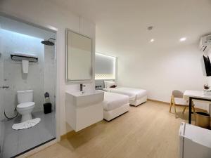 a bathroom with a toilet and a sink and a mirror at Arawana Express Sukhumvit 22 in Bangkok