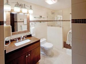 a bathroom with a sink and a toilet and a mirror at Simpson Bay Resort Marina & Spa in Simpson Bay