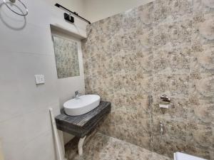 a bathroom with a white sink and a shower at The Life Style Lodges opp Centaurus Mall in Islamabad