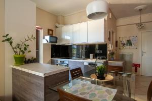 a kitchen with a counter and a dining room at Sea Escape apartment in Chalkida