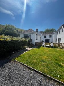 a house with a yard with a bench in it at The Danes Gower, Llanmadoc, Gower in Swansea