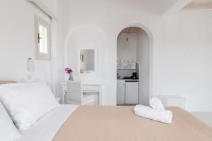 Rúm í herbergi á Fos Apartments Mykonos