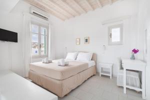 Rúm í herbergi á Fos Apartments Mykonos