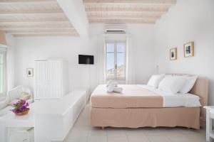 Rúm í herbergi á Fos Apartments Mykonos