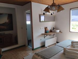 a bedroom with a bed and a mirror at Aloxamento A Mariña in Oia