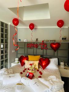 a bed with red hearts and a sign that reads china life at Fonte Retreat Premium Suite in Sandim