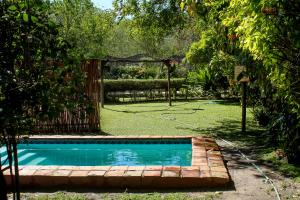 a swimming pool in a yard with a fence at Thamalakane guest house in Maun