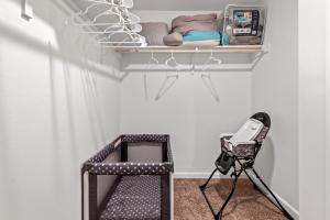 a camera in a room with a shelf and a chair at Spacious & Comfy KING Bed with Garage in Lake Charles in Lake Charles