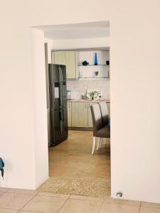 a kitchen with a stainless steel refrigerator and a chair at Sofia's Bungalows Mykonos in Mýkonos City