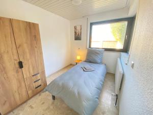 Ένα ή περισσότερα κρεβάτια σε δωμάτιο στο K41 - Haus mit Garten - Max 8 Personen - ab 5 Nächte - Perfekt für Geschäftsreisende,Teams,Monteure I Messe I A81 I Stuttgart