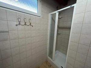 a bathroom with a shower and a glass door at R-Home Apartman in Zamárdi +10 photos