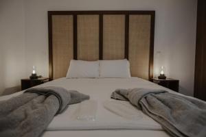 a bedroom with a bed with towels on it at PanMari in Paphos City