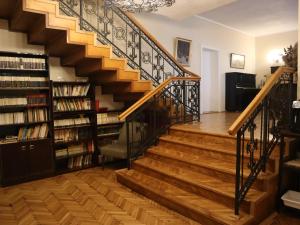 a staircase in a home with bookshelves at Kesletz House in Sibiu