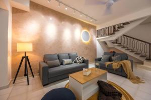 a living room with a couch and a staircase at New!14pax,Petaling Jaya Damansara Landed Home next Starling Atria Mall 1U IKEA in Petaling Jaya