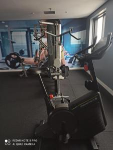 a gym with a machine in a room at Hotel Guarulhos Slaviero Apto1808 in Guarulhos