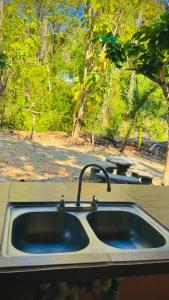 a kitchen sink with a faucet on top of it at Mal Pais Surf Camp in Santa Teresa Beach