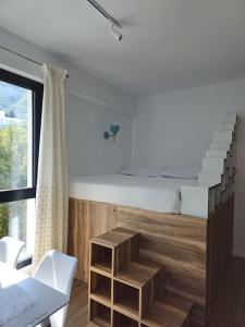 a living room with a staircase and a table and chairs at Condo "Comfort" in Vlorë