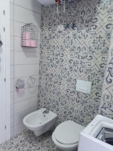 a bathroom with a toilet and a sink at Condo "Comfort" in Vlorë