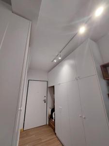 a room with a white wall and a white door at Condo "Comfort" in Vlorë