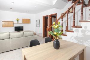 a living room with a table and a couch at Apartamentos el Acebo in Naves