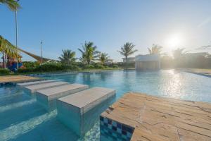 a large swimming pool with steps in the water at Kuza The Palm Villas at Vipingo in Kilifi