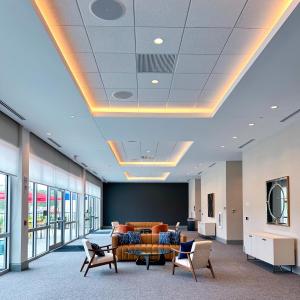 un vestíbulo de oficina con sofá, sillas y ventanas en Home2 Suites By Hilton Fort Walton Beach, en Fort Walton Beach