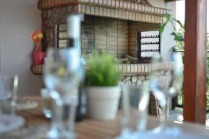 a table with glasses on a table with a fireplace at Petralia's Guest House in Skiathos