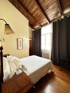 a bedroom with a bed and a large window at Hotel Casa Soto in Vegadeo