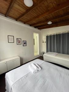 a bedroom with two beds and a window at Casa c/ bela vista para Baía Sul in Florianópolis
