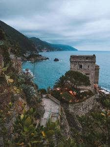 an old building on the side of a body of water at Cuccaro Club - Val di Vara e Cinque Terre in Rocchetta di Vara